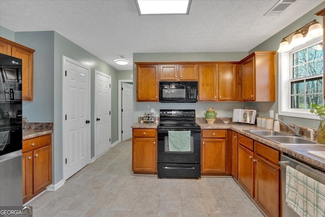 81 Summer Creek Dr, Dallas, GA 30157 - kitchen with visible vents, black appliances, brown cabinets, a textured ceiling, and a sink
