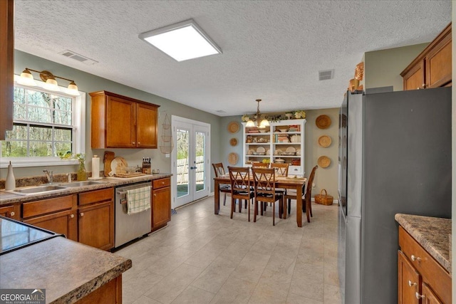 81 Summer Creek Dr, Dallas, GA 30157 - kitchen with brown cabinetry, visible vents, and stainless steel appliances