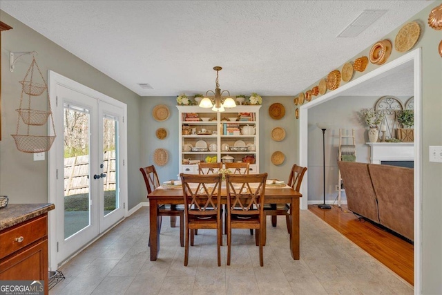81 Summer Creek Dr, Dallas, GA 30157 - dining space with baseboards, visible vents, an inviting chandelier, french doors, and a textured ceiling