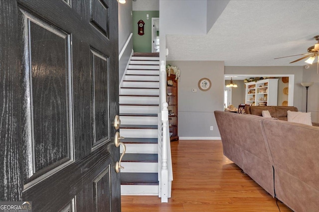 81 Summer Creek Dr, Dallas, GA 30157 - stairs with baseboards, wood finished floors, a textured ceiling, and ceiling fan