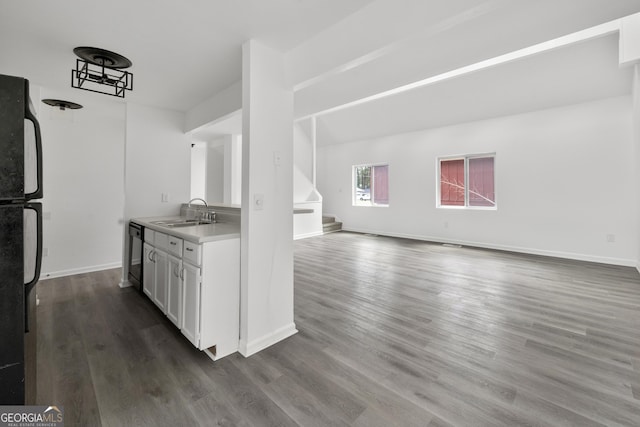 kitchen featuring dark wood finished floors, white cabinetry, black appliances, and a sink