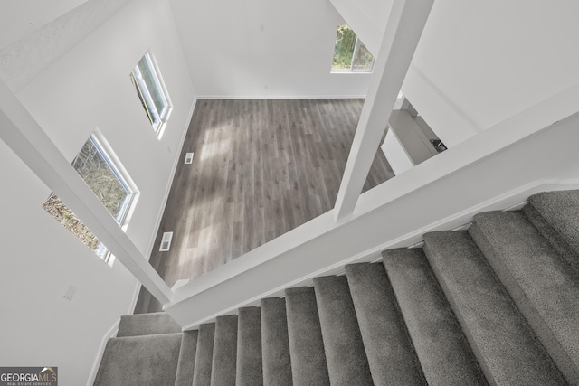 stairs featuring baseboards and wood finished floors