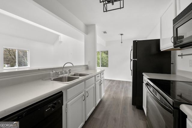 kitchen featuring white cabinets, light countertops, dark wood-type flooring, a sink, and black appliances