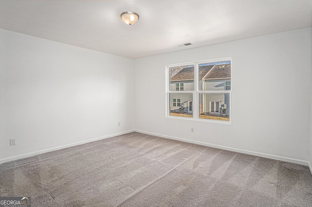 spare room with carpet flooring and baseboards