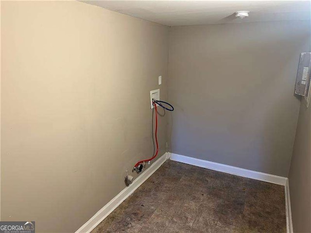laundry room with baseboards, washer hookup, dark floors, and laundry area