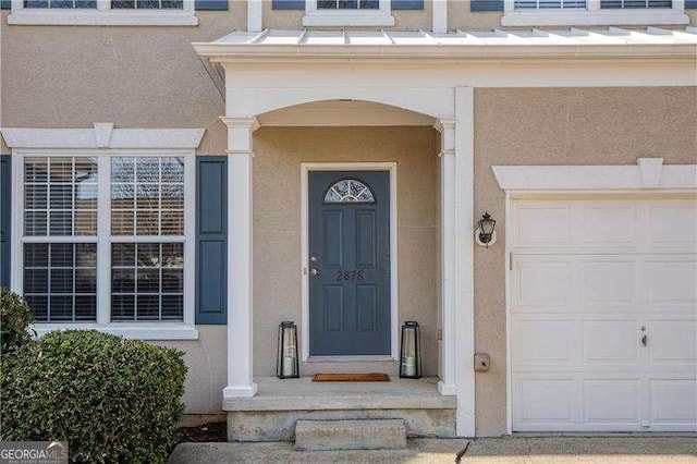 property entrance featuring stucco siding