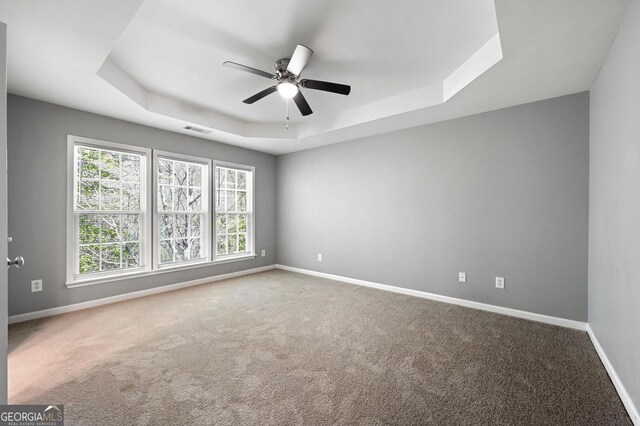 3258 Welmingham Dr SW, Atlanta, GA 30331 - empty room with a healthy amount of sunlight, baseboards, visible vents, a ceiling fan, and a tray ceiling