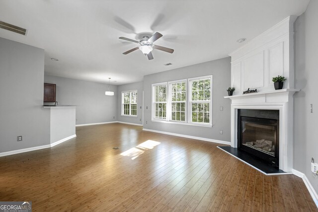 3258 Welmingham Dr SW, Atlanta, GA 30331 - unfurnished living room featuring baseboards, visible vents, ceiling fan, and a large fireplace