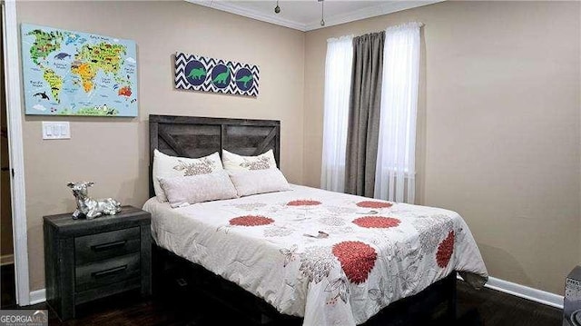 bedroom with multiple windows, baseboards, and crown molding