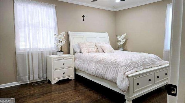 bedroom featuring dark wood-style floors and crown molding
