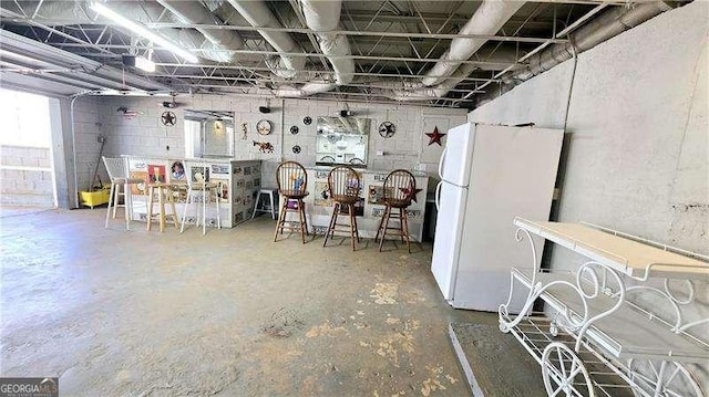 below grade area with freestanding refrigerator