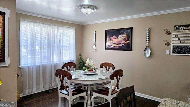 dining space featuring dark wood finished floors, baseboards, and ornamental molding