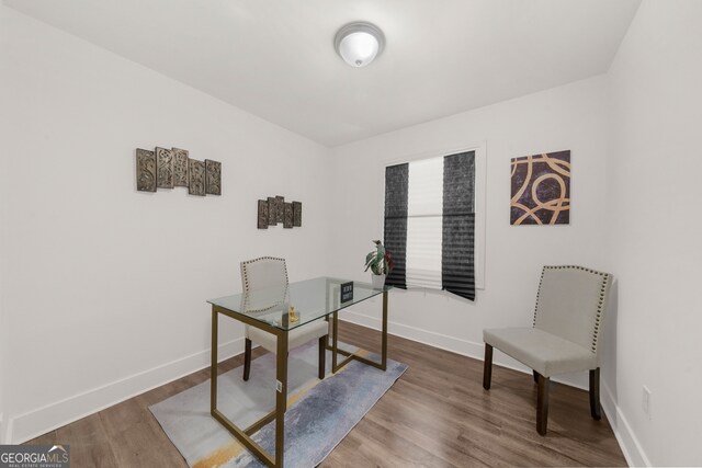 office area featuring wood finished floors and baseboards
