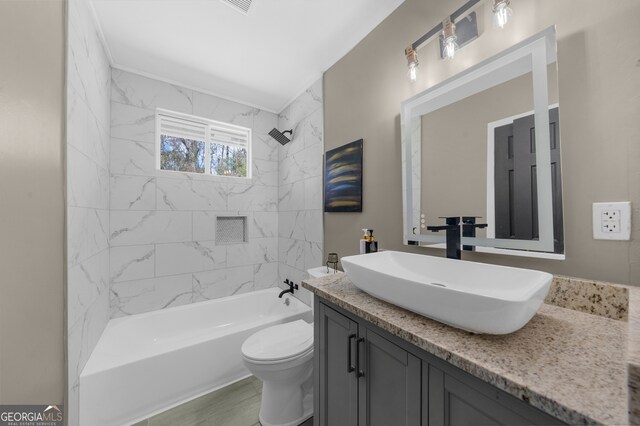 bathroom with toilet, tub / shower combination, and vanity