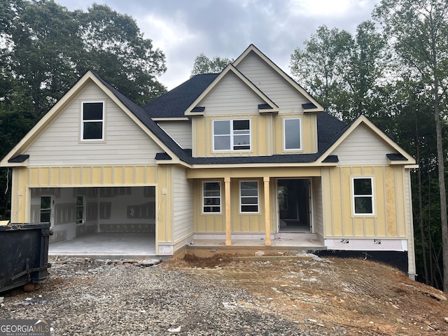 221 Autumn Brook Dr, Canton, GA 30115 - view of front of home featuring board and batten siding, roof with shingles, a porch, gravel driveway, and an attached garage