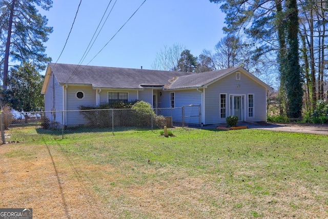 ranch-style house featuring a front lawn and fence