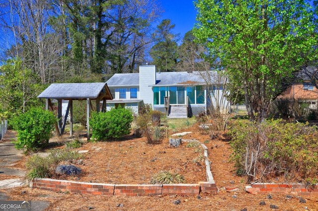 single story home with a chimney