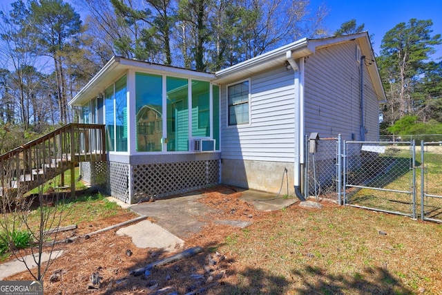 view of front of home featuring fence and a gate