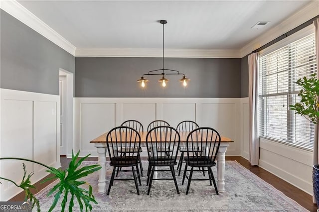9085 Maple Run Trl, Gainesville, GA 30506 - dining space featuring crown molding, a decorative wall, a wainscoted wall, and wood finished floors