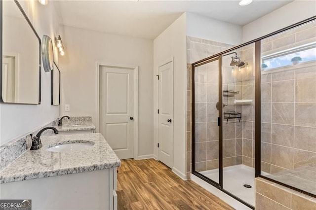9085 Maple Run Trl, Gainesville, GA 30506 - full bath featuring a shower stall, double vanity, and wood finished floors