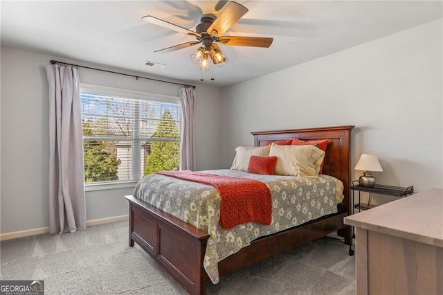 bedroom featuring baseboards, a ceiling fan, visible vents, and light colored carpet