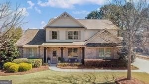 view of front facade featuring a front lawn and covered porch