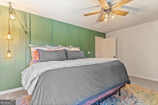 bedroom with ceiling fan, carpet floors, visible vents, and baseboards