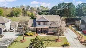 9085 Maple Run Trl, Gainesville, GA 30506 - view of front of home with fence, driveway, a front yard, and a garage