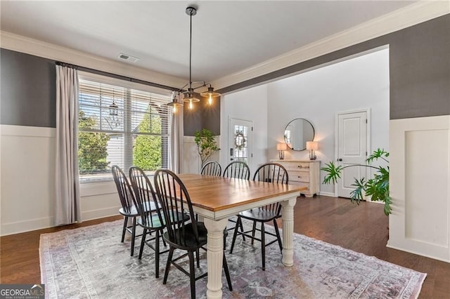 9085 Maple Run Trl, Gainesville, GA 30506 - dining area featuring visible vents, crown molding, wood finished floors, a wainscoted wall, and a decorative wall