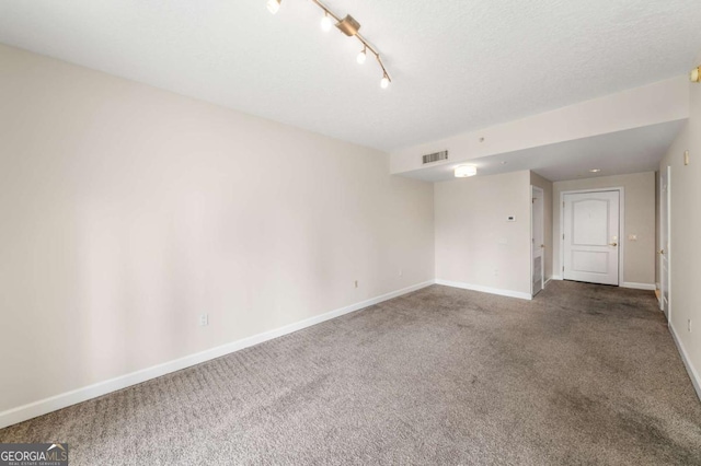 195 14th St NE Unit 1404, Atlanta, GA 30309 - empty room with carpet flooring, baseboards, visible vents, and a textured ceiling
