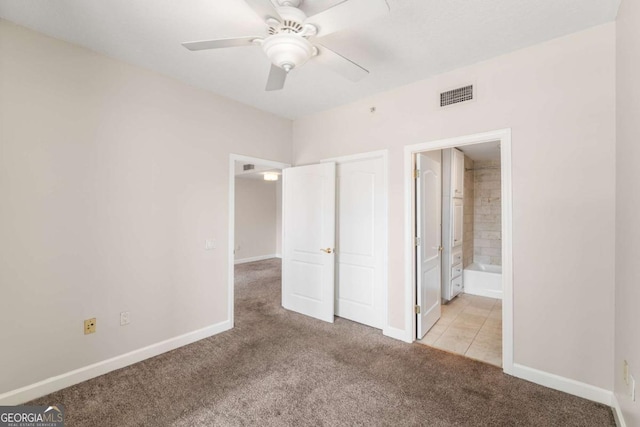 195 14th St NE Unit 1404, Atlanta, GA 30309 - unfurnished bedroom with a ceiling fan, baseboards, visible vents, ensuite bath, and light carpet