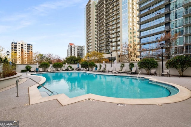 195 14th St NE Unit 1404, Atlanta, GA 30309 - community pool featuring a patio area and fence
