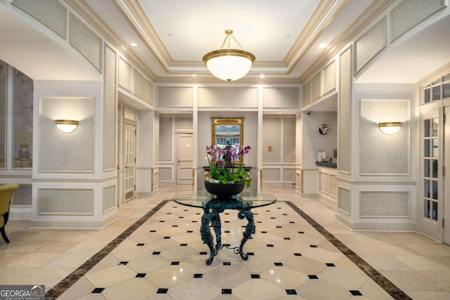 195 14th St NE Unit 1404, Atlanta, GA 30309 - foyer entrance with baseboards, a tray ceiling, arched walkways, ornamental molding, and a decorative wall