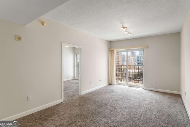 195 14th St NE Unit 1404, Atlanta, GA 30309 - carpeted empty room featuring baseboards and a textured ceiling
