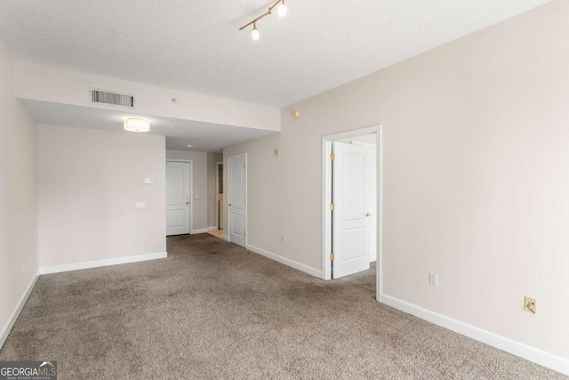 195 14th St NE Unit 1404, Atlanta, GA 30309 - spare room with visible vents, baseboards, a textured ceiling, and carpet flooring