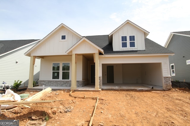 2044 Ripple Park Bnd, Canton, GA 30114 - view of front of property featuring board and batten siding, stone siding, roof with shingles, and driveway