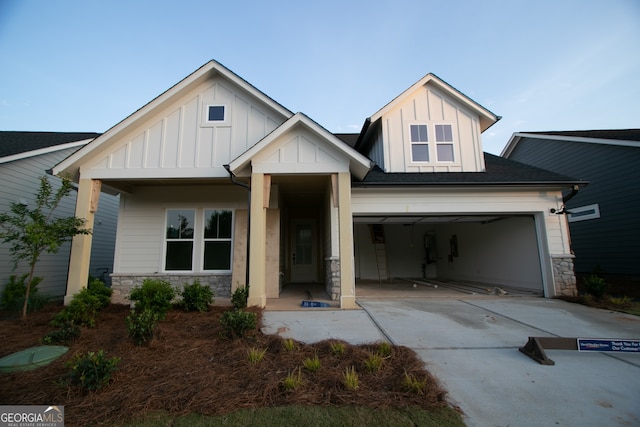 2044 Ripple Park Bnd, Canton, GA 30114 - view of front facade featuring board and batten siding, stone siding, concrete driveway, and an attached garage