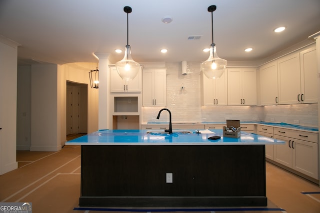 2044 Ripple Park Bnd, Canton, GA 30114 - kitchen featuring decorative backsplash, a center island with sink, white cabinetry, decorative light fixtures, and recessed lighting