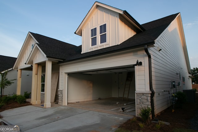 2044 Ripple Park Bnd, Canton, GA 30114 - view of side of property featuring driveway, roof with shingles, board and batten siding, a garage, and stone siding