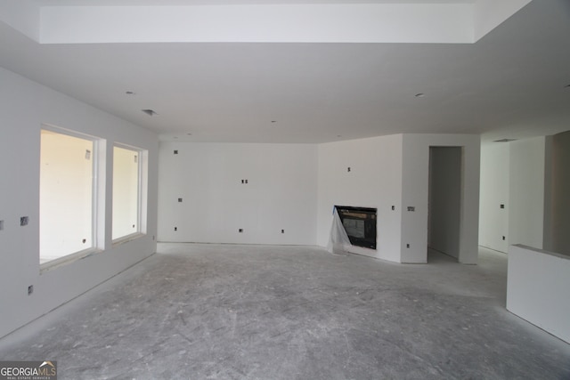 2044 Ripple Park Bnd, Canton, GA 30114 - unfurnished living room featuring unfinished concrete flooring and a glass covered fireplace