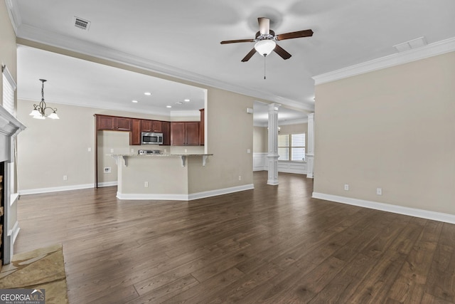 unfurnished living room featuring ornamental molding, a ceiling fan, decorative columns, visible vents, and dark wood-style floors