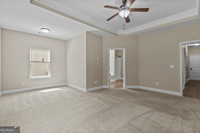 unfurnished room with a ceiling fan, baseboards, ornamental molding, and carpet