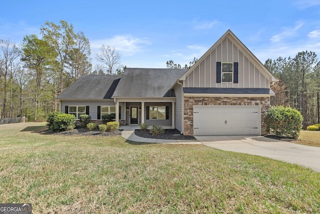 craftsman-style house with board and batten siding, a front yard, driveway, and stone siding