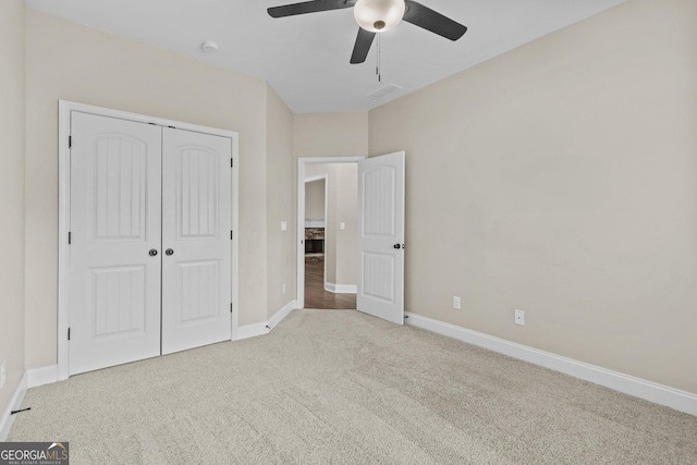 unfurnished bedroom with ceiling fan, carpet, baseboards, visible vents, and a closet