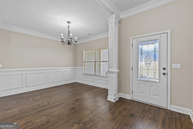 entrance foyer featuring crown molding, visible vents, decorative columns, dark wood-style floors, and a notable chandelier