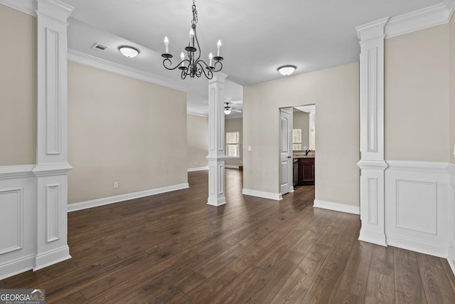 unfurnished dining area with baseboards, visible vents, decorative columns, and dark wood-type flooring