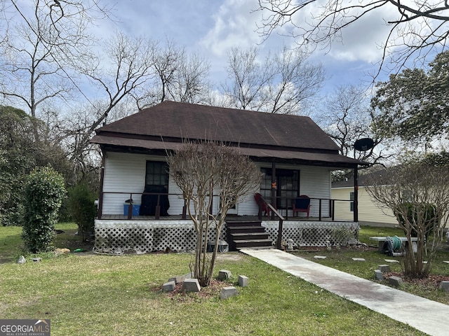 113 Palm St, Cochran, GA 31014 - bungalow with covered porch, a front yard, and roof with shingles