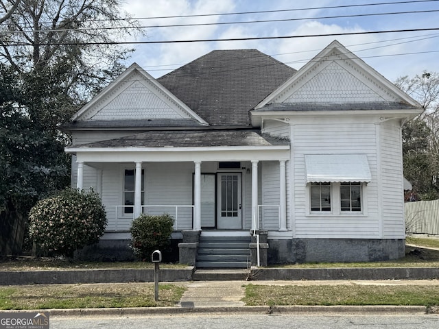 108 N Washington St, Dublin, GA 31021 - view of front of house featuring roof with shingles and a porch