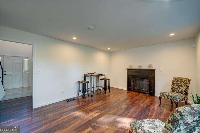 77 Hunters Grn, Dallas, GA 30157 - sitting room with visible vents, a glass covered fireplace, and wood finished floors
