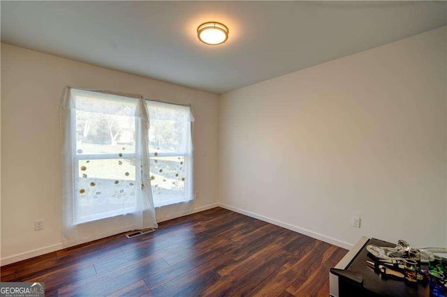 77 Hunters Grn, Dallas, GA 30157 - empty room featuring visible vents, dark wood-style floors, and baseboards